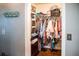 Organized walk-in closet with ample storage space and a variety of clothing neatly arranged at 811 W Heron Pl, Winter Haven, FL 33884