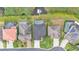 Bird's eye view of multiple backyard swimming pools adjacent to a lake at 1342 Heritage Landings Dr, Lakeland, FL 33805