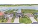 Aerial view of a beautiful home with a manicured lawn and serene lake views at 1342 Heritage Landings Dr, Lakeland, FL 33805