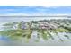 An aerial view of waterfront homes surrounding a lake with lilly pads and nearby city at 1342 Heritage Landings Dr, Lakeland, FL 33805