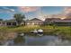 Home's backyard features a screened patio and dock with a boat on the waterfront at 1342 Heritage Landings Dr, Lakeland, FL 33805