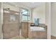 Bathroom with a walk-in shower and a soaking tub. The walls are tiled and the space is well lit at 1342 Heritage Landings Dr, Lakeland, FL 33805