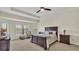 Large bedroom with a tray ceiling, carpeted floors, and plenty of natural light at 1342 Heritage Landings Dr, Lakeland, FL 33805