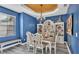 Dining room featuring blue walls, decorative ceiling, and custom decor at 1342 Heritage Landings Dr, Lakeland, FL 33805