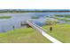 Scenic view of a pier reaching out into a lake with lilly pads and grass at 1342 Heritage Landings Dr, Lakeland, FL 33805