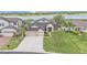 Inviting home featuring a well-manicured lawn, lush landscaping, and a convenient two-car garage at 1342 Heritage Landings Dr, Lakeland, FL 33805