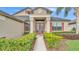 Charming front entrance featuring a well-manicured garden, double doors, and a welcoming facade at 1342 Heritage Landings Dr, Lakeland, FL 33805