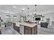Spacious kitchen with a large island, farmhouse sink, and an open concept to the living room at 1342 Heritage Landings Dr, Lakeland, FL 33805