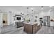 Open-concept kitchen and living room with a large island, stainless steel appliances, and breakfast nook at 1342 Heritage Landings Dr, Lakeland, FL 33805