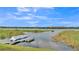 Enjoy this scenic lake view from the property with a boat dock and lush greenery at 1342 Heritage Landings Dr, Lakeland, FL 33805