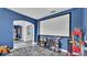 Bright media room with large projector screen, blue walls, and unique decor at 1342 Heritage Landings Dr, Lakeland, FL 33805