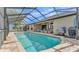 Enjoy the large screened pool with an outdoor seating area overlooking the lake at 1342 Heritage Landings Dr, Lakeland, FL 33805