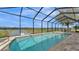 Inviting pool overlooking a serene lake, perfect for relaxation and entertainment at 1342 Heritage Landings Dr, Lakeland, FL 33805
