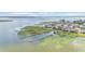 Waterfront property features a lake view with lilly pads, boat dock, and nearby houses at 1342 Heritage Landings Dr, Lakeland, FL 33805