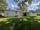 Expansive backyard with well-maintained lawn, adjacent to home and Florida room at 1528 Hallam S Ct, Lakeland, FL 33813