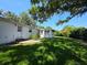 Expansive backyard featuring a well-maintained lawn, mature trees, and exterior of the house at 1528 Hallam S Ct, Lakeland, FL 33813