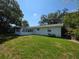 Expansive backyard featuring lush green grass and mature trees at 1528 Hallam S Ct, Lakeland, FL 33813