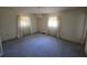 Bedroom with carpet, two windows and a classic chandelier at 1528 Hallam S Ct, Lakeland, FL 33813