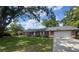 Well-maintained single-story home with a brick exterior, attached garage, and lush lawn at 1528 Hallam S Ct, Lakeland, FL 33813
