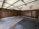 Large two-car garage with wood paneled walls and automatic door opener at 1528 Hallam S Ct, Lakeland, FL 33813