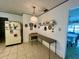 Dining area with tile flooring adjacent to kitchen; refrigerator included at 1528 Hallam S Ct, Lakeland, FL 33813