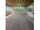 Bright sun room with paneled walls, wood beam ceiling and large windows overlooking the yard at 1528 Hallam S Ct, Lakeland, FL 33813