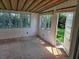 Inviting sun room featuring wood-beamed ceiling and an open doorway to the outdoor green space at 1528 Hallam S Ct, Lakeland, FL 33813