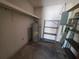 A utility room with a hot water tank and shelving for storage solutions at 1528 Hallam S Ct, Lakeland, FL 33813
