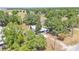Aerial view of property nestled among mature trees, showcasing a charming home with a well-maintained landscape at 1650 W Mcleod St, Bartow, FL 33830