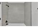 A tiled shower stall with gray subway tiles, a black showerhead and black shower handle and trim at 1650 W Mcleod St, Bartow, FL 33830