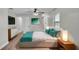 Comfortable bedroom featuring a ceiling fan, white walls, and wood floors at 1650 W Mcleod St, Bartow, FL 33830