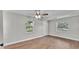 Bright bedroom with two windows, wood floors and ceiling fan at 1650 W Mcleod St, Bartow, FL 33830