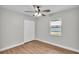 Bedroom features wood floors, closet, ceiling fan, and natural light at 1650 W Mcleod St, Bartow, FL 33830