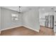 Bright dining area adjacent to kitchen features modern light fixture and laminate floors at 1650 W Mcleod St, Bartow, FL 33830