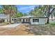 Charming single-story home with white facade, dark trim, and a welcoming screened-in porch at 1650 W Mcleod St, Bartow, FL 33830