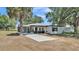 Charming single-story home with white facade, dark trim, and a welcoming screened-in porch at 1650 W Mcleod St, Bartow, FL 33830