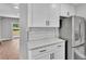 The kitchen features stainless steel appliances, white cabinets, and laminate floors at 1650 W Mcleod St, Bartow, FL 33830