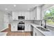 Well-lit kitchen with stainless steel appliances, white cabinets, and modern backsplash at 1650 W Mcleod St, Bartow, FL 33830