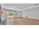 Bright and airy living room featuring a brick fireplace, hardwood floors, a sliding glass door and a backyard view at 1650 W Mcleod St, Bartow, FL 33830