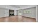 Open-concept living room showcasing a brick fireplace, hardwood floors, recessed lighting, and a sliding glass door at 1650 W Mcleod St, Bartow, FL 33830