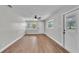 Sunlit living room features wood flooring and access to the backyard through a glass door at 1650 W Mcleod St, Bartow, FL 33830