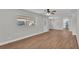 Living room showcasing wood floors, a window, and a door leading to the backyard at 1650 W Mcleod St, Bartow, FL 33830