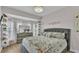 Comfortable bedroom featuring a large window, dresser, and a beautifully decorated queen-sized bed at 1983 Via Lago Dr, Lakeland, FL 33810