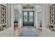 Elegant foyer featuring high ceilings, beautiful decorative doors, transom windows and tile flooring at 1983 Via Lago Dr, Lakeland, FL 33810