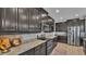 Spacious kitchen featuring dark wood cabinetry, granite countertops, and stainless steel appliances at 1983 Via Lago Dr, Lakeland, FL 33810
