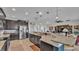 Well-lit kitchen with dark cabinets, granite countertops, pendant lighting, breakfast bar and stainless appliances at 1983 Via Lago Dr, Lakeland, FL 33810