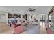 Open-concept living space with a view of kitchen, breakfast bar, arched doorways, and comfortable seating at 1983 Via Lago Dr, Lakeland, FL 33810
