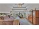 Serene bedroom with tray ceiling, ample natural light, hardwood floors, and a view of the landscaped property at 1983 Via Lago Dr, Lakeland, FL 33810