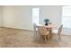 Inviting living room featuring neutral carpet, plenty of natural light, and a dining table with stylish seating at 4139 Cobblestone Dr, Lakeland, FL 33813