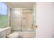 Cozy bathroom with a shower and tub combination and an elegant glass door at 635 Cottage Ln # 635, Lakeland, FL 33803